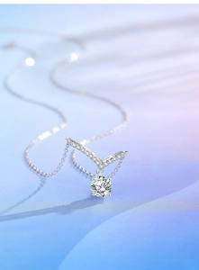 Macro shot of 925 silver V-shaped necklace with round moissanite and pave-set accents