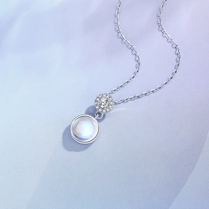 S925 sterling silver necklace with a round moonstone pendant on purple silk fabric