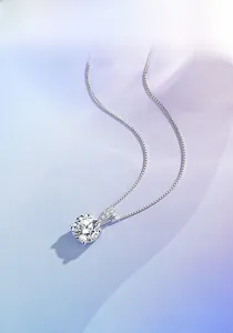 Detail of S925 silver necklace featuring a sparkling 4-prong round cut solitaire pendant