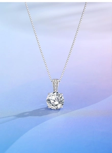 Macro detail of 2ct round solitaire diamond pendant with sparkling four-prong setting