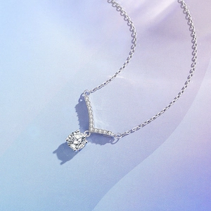Sparkling V-shaped 925 silver necklace with round moissanite pendant on blue background