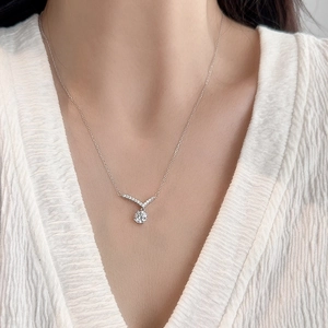 Sparkling 925 sterling silver V-shape moissanite necklace displayed on a model's neck