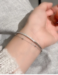 Detail of S925 sterling silver double-layer bracelet set with micro-pave crystals on wrist