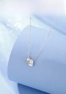 Close-up of S925 silver necklace with sparkling waterdrop and round moissanite pendants
