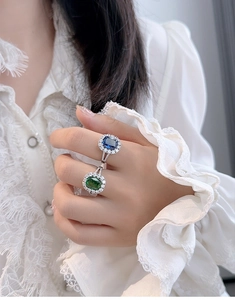Close-up of S925 sterling silver rings with radiant cut blue and green sapphire stones