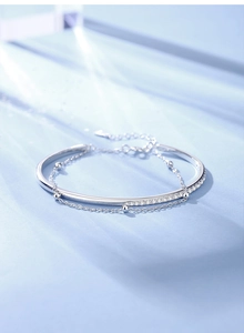 Macro shot of S925 sterling silver double-layer bracelet with beads and sparkling crystals