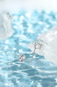Detail of 925 sterling silver four-claw stud earrings on a blue ice and water background
