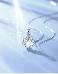 Macro shot of S925 sterling silver cat paw necklace featuring white chalcedony heart pendant