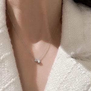 Elegant S925 sterling silver necklace featuring double moissanite stone pendants on a woman