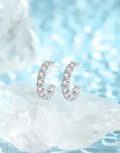 Close-up of S925 silver hoop earrings featuring rows of brilliant pavé set cubic zirconia