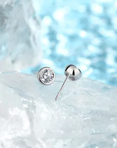 Macro detail of S925 sterling silver moissanite studs with hallmark on ice background