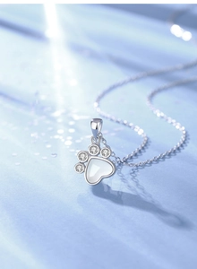 Close-up of S925 silver cat paw pendant with white chalcedony and cubic zirconia stones