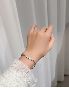 Macro shot of a 925 sterling silver Cuban chain bracelet with paved diamond bar for women