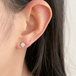 Classic 925 silver 5mm stud earring with six-prong setting on a female model