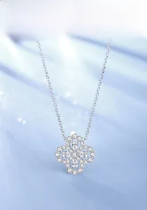Macro view of a shimmering silver S925 clover pendant necklace with detailed pavé diamonds
