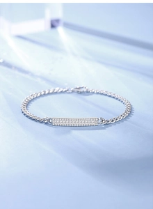 Macro shot of 925 silver Cuban link bracelet with a rectangle micro-pave zircon charm
