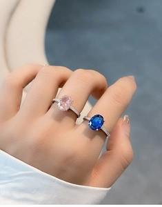 Close-up of S925 silver rings with radiant cut pink and royal blue sapphire gemstones