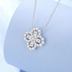S925 sterling silver four-leaf clover necklace with sparkling pear-cut gems on blue stand