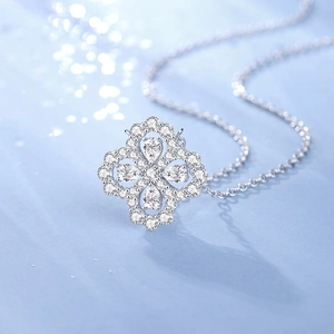 Sparkling S925 sterling silver clover necklace featuring pear-shaped gemstones on blue background