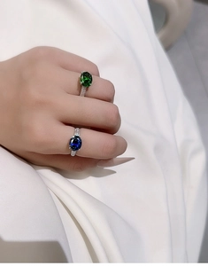 Macro shot of S925 silver rings set with blue and green sapphires on hand
