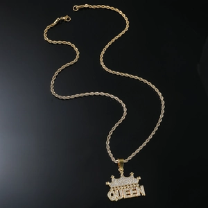 Macro view of gold plated QUEEN crown pendant with sparkling crystals on twisted chain