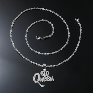 Close-up of silver Queen letter pendant with crown and iced out rhinestones on rope chain