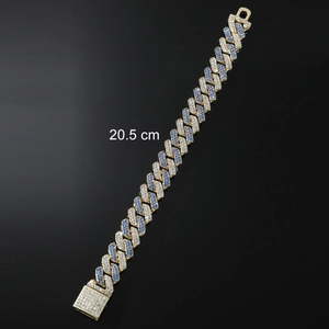 Macro shot of gold Cuban link bracelet with blue and white pavé cubic zirconia gemstones