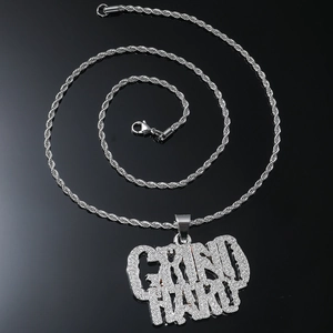 Macro shot of silver GRIND HARD iced out pendant with twisted rope chain necklace