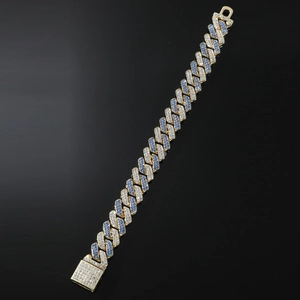 Macro shot of Cuban link bracelet with blue and white zircons on black mirror base