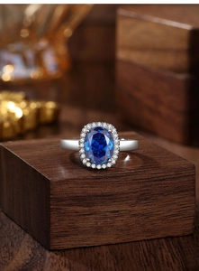 Close-up of radiant cut royal blue sapphire ring in S925 silver with diamond halo