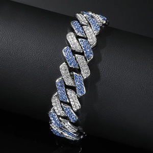 Iced out hip hop Cuban link bracelet with white and blue stones on jewelry stand