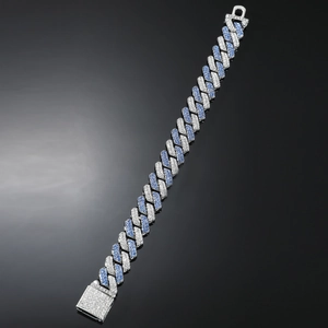 Macro shot of silver Cuban link bracelet with blue and white pavé-set rhinestones