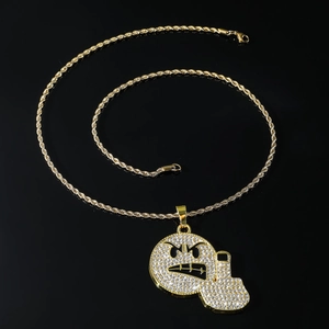 Iced out emoji face and pistol pendant on a gold rope chain necklace for hip hop style