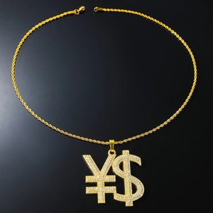 Macro detail of iced-out gold dollar and yen sign pendant with crystal rhinestones