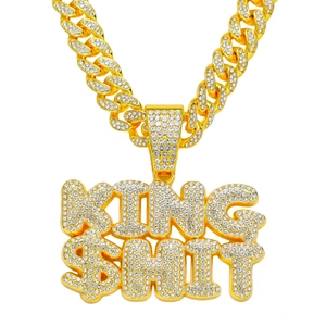 Macro shot of Cuban link chain with icy rhinestone-paved KING SHIT letter pendant