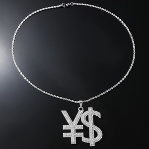 Macro shot of hip hop silver dollar and yen sign pendant with iced-out rhinestones