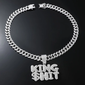 Macro shot of silver paved Cuban link chain with iced out KING SHIT letter pendant