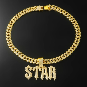 Detailed view of iced-out gold Cuban chain necklace with sparkling STAR letter pendant