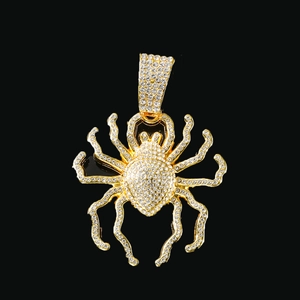 Gros plan détaillé d'un pendentif araignée dorée serti de strass sur fond noir