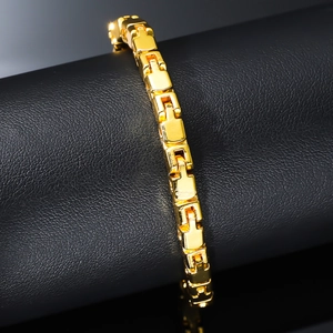 Polished gold curb link bracelet for men and women on premium black leather surface