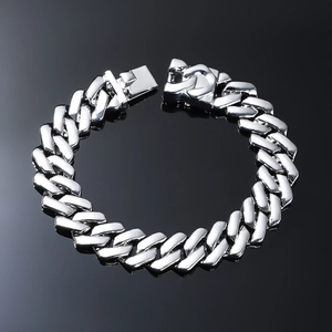 Macro detail of silver Cuban link bracelet with high-polish finish and secure square clasp
