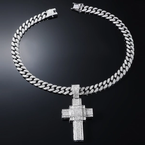 Gros plan sur un collier gourmette hip hop avec pendentif croix pavé de strass argenté