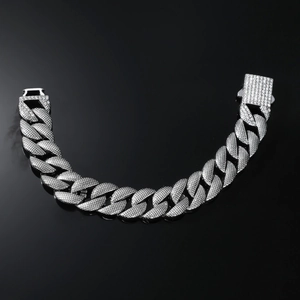 Macro-opname van zilveren Cubaanse armband met ingelegde diamanten en vierkante sluiting