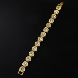 Macro shot of hip hop gold plated round link bracelet with cubic zirconia on black base