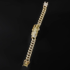 Gold iced out Cuban link bracelet featuring a diamond-encrusted Jesus piece with secure clasp