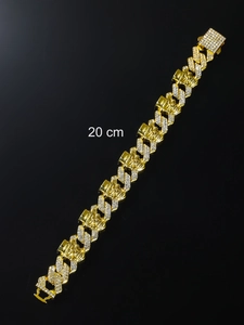 Detail view of 20 cm golden punk skull bracelet with sparkling stones and cuban link chain