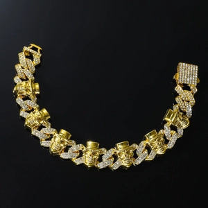 Iced out gold skull bracelet with top hat charms and Cuban links for hip hop style