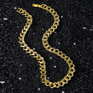 12mm golden Cuban link chain for men featuring heart-shaped links on black crushed stones
