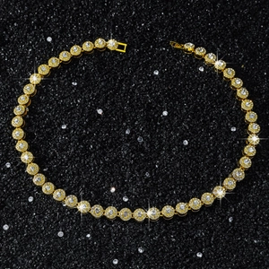 Detail of 10mm golden tennis chain necklace featuring round cut cubic zirconia stones