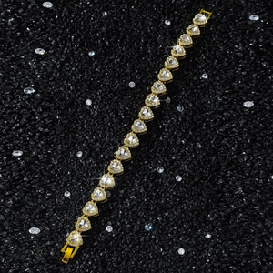Detalle del collar de eslabones de corazón dorado con pedrería brillante y piedras de circón